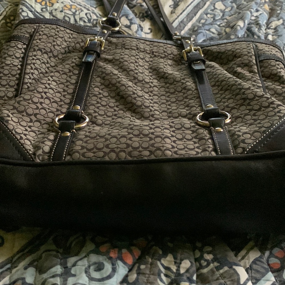 Women gently used Coach tote bag free of any rips, tears, stains and smells.